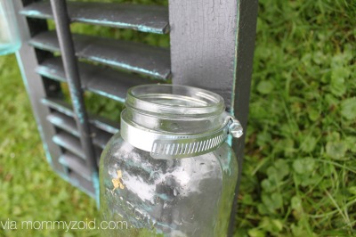 Repurpose an old shutter with mason jars to create a flower wall via www.mommyzoid.com